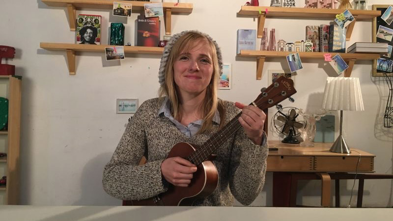 The first teacher on the VIPKid platform, Madli Rohtla holding a brown ukulele.